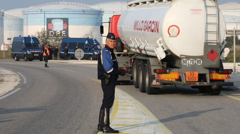Police block the Fos-sur-Mer oil depot, allowing only trucks through, southern France, Friday Oct. 15, 2010. (AP Photo/Claude Paris)