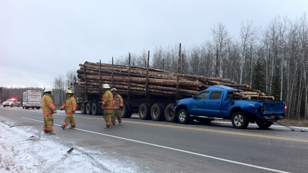 Pickup truck rear ends logging truck