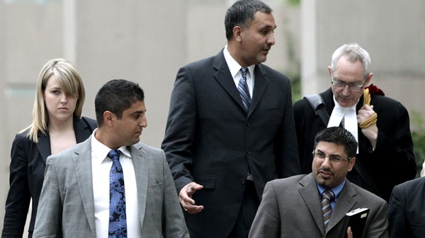 Dave Basi, centre, and his lawyer Michael Bolton, far right, Bobby Virk, lower right, and Aneal Basi, 2nd left, and his lawyer Erin Dance, left, leave B.C. Supreme Court in Vancouver, B.C., on Monday October 18, 2010. (Darryl Dyck / THE CANADIAN PRESS)