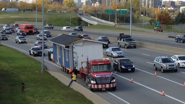 A construction shack travelling along the eastbound Queensway was too tall for the Lees Ave. overpass and got stuck right underneath.