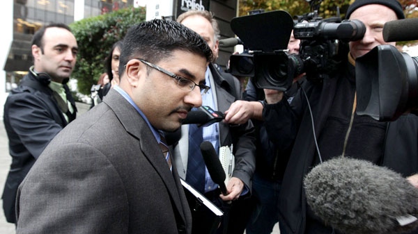 Bobby Virk, centre, leaves B.C. Supreme Court in Vancouver, B.C., on Monday October 18, 2010. (Darryl Dyck / THE CANADIAN PRESS)