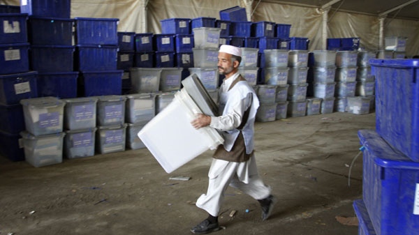 An Afghan election worker carries ballot boxes at the warehouse of Afghanistan's Independent Election Commission in Kabul, Afghanistan on Tuesday, Sept. 21, 2010. (AP / Musadeq Sadeq)