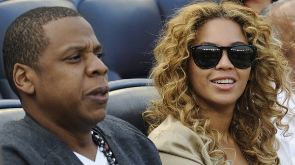 Entertainers Jay-Z, left, and Beyonce watch a baseball game between the New York Yankees and Minnesota Twins Friday, May 14, 2010 at Yankee Stadium in New York. (AP Photo/Bill Kostroun)