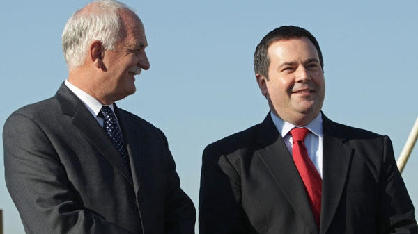 Minister of Public Safety Vic Toews, left, and Minister of Citizenship, Immigration and Multiculturism Jason Kenney stand together after announcing a proposed law that would bring harsher penalties to combat human smuggling in Delta, B.C., on Thursday October 21, 2010. (Darryl Dyck / THE CANADIAN PRESS)