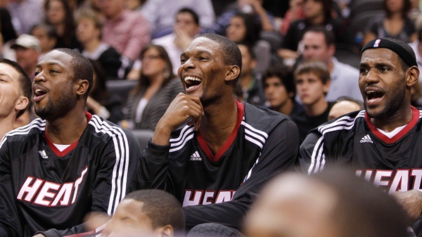 Miami Heat's Dwyane Wade, left, Chris Bosh, centre, and LeBron James react on the bench during the second quarter of an NBA preseason basketball game against the San Antonio Spurs, Saturday, Oct. 9, 2010 in San Antonio. (AP / Eric Gay)