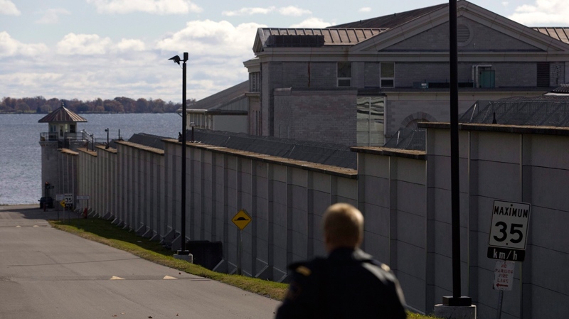 A guard patrols outside Kingston Penitentiary in Kingston, Ont., on Thursday, Oct. 21, 2010. (Lars Hagberg / THE CANADIAN PRESS)  