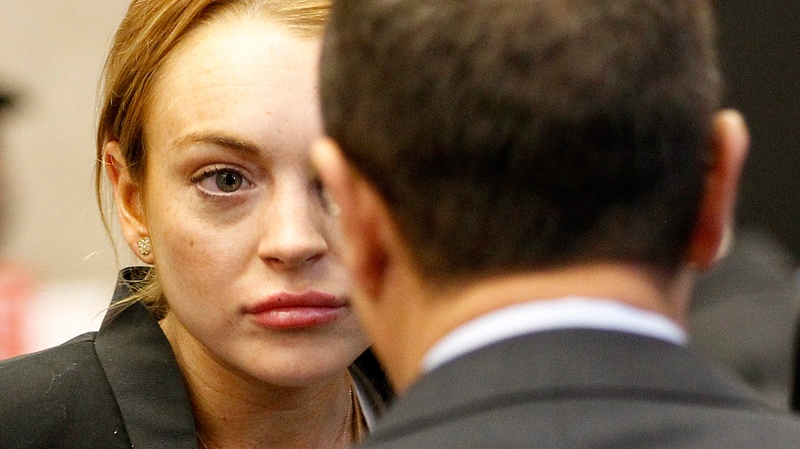 Lindsay Lohan looks at a court official as she arrives for a probation violation hearing at Beverly Hills Courthouse in Beverly Hills, Calif., Friday, Oct. 22, 2010. (AP / Mario Anzuoni)