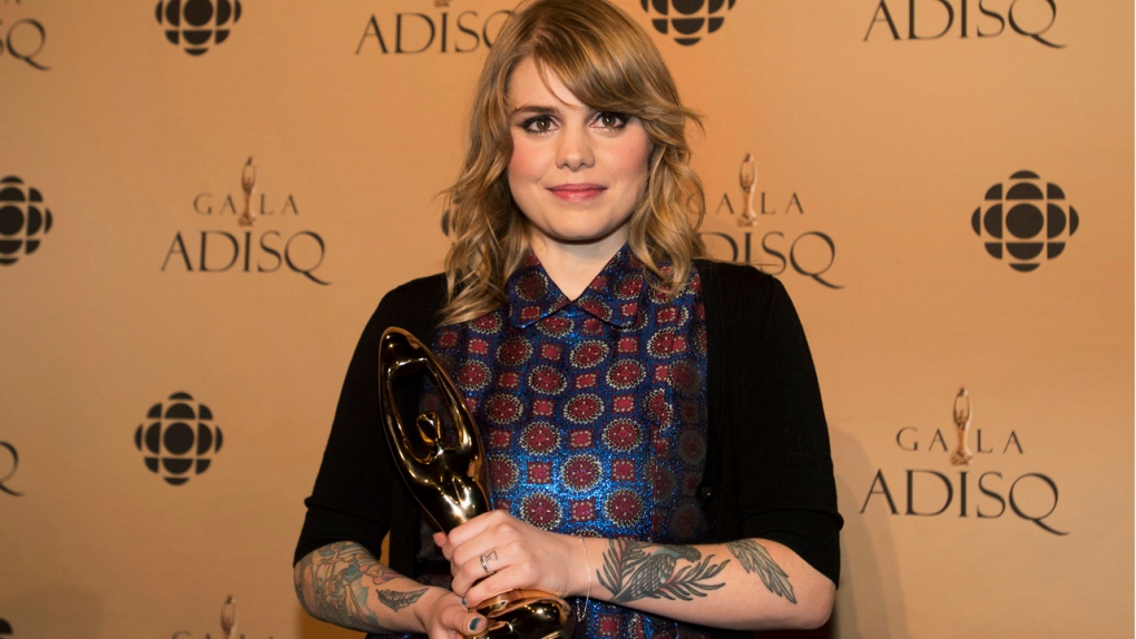 Coeur de pirate holds up her Felix award for best 