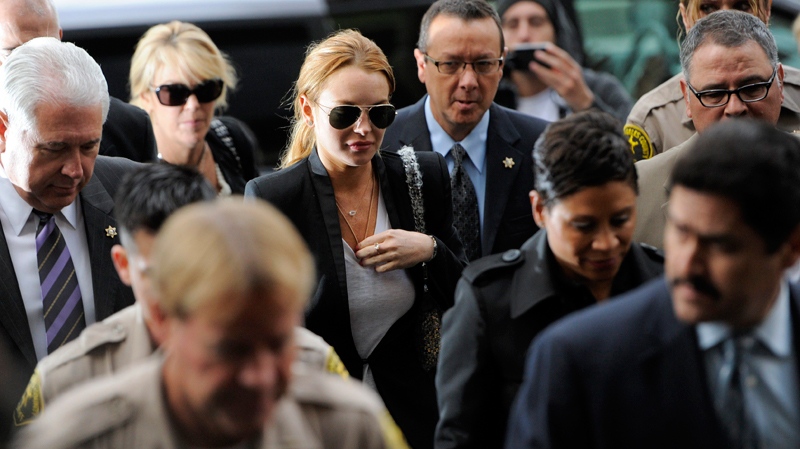 Lindsay Lohan, centre, arrives for a probation violation hearing at Beverly Hills Courthouse in Beverly Hills, Calif., Friday, Oct. 22, 2010. (AP / Chris Pizzello)