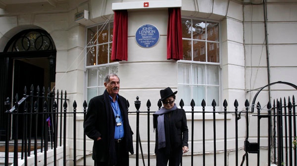 Artist and musician Yoko Ono, right, poses with Beatles biographer Hunter Davies in front of a Blue Plaque to honour John Lennon during an unveiling ceremony at 34 Montagu Square in London, Saturday, Oct. 23, 2010. (AP / Sang Tan)