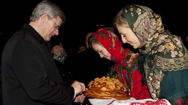 Prime Minister Stephen Harper receives a gift of bread and salt from women in national dress as he arrives in the region of Kyiv, Ukraine on Sunday, Oct. 24, 2010.(THE CANADIAN PRESS/Sean Kilpatrick)