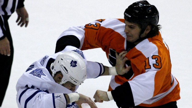 Toronto Maple Leafs' Mike Brown, left, and Philadelphia Flyers' Daniel Carcillo (13) fight in the first period of an NHL hockey game Saturday, Oct. 23, 2010, in Philadelphia. (AP Photo/H. Rumph, Jr.)