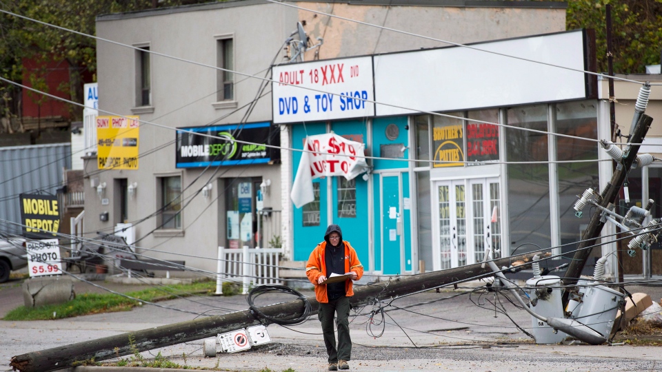 A hydro worker overlooks the damage in Toronto