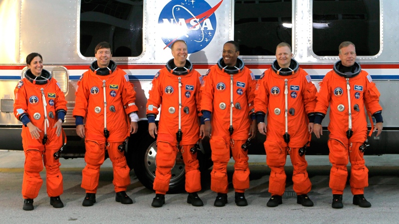 The crew of space shuttle Discovery, from left, mission specialists Nicole Stott, Michael Barratt, Tim Kopra and Alvin Drew, pilot Eric Boe and commander Steve Lindsey, leave the Operations and Checkout Building to board the shuttle at pad 39A for a launch dress rehearsal at the Kennedy Space Center in Cape Canaveral, Fla., Friday, Oct. 15, 2010. Discovery is scheduled to launch Nov. 1. (AP / John Raoux)