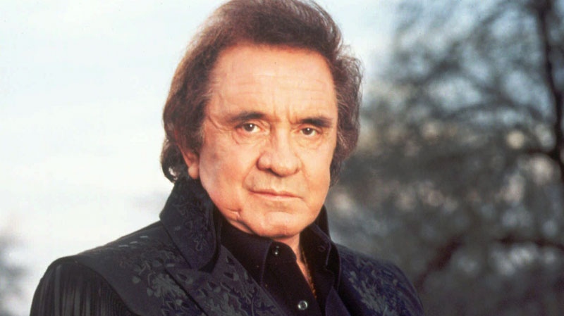Singer Johnny Cash is shown in this 1995 publicity photo. The man in black will be bringing in some green when Johnny Cash's guitars, costumes, handwritten lyrics and personal belongings go on the auction block. (TBS / Mark Hill)