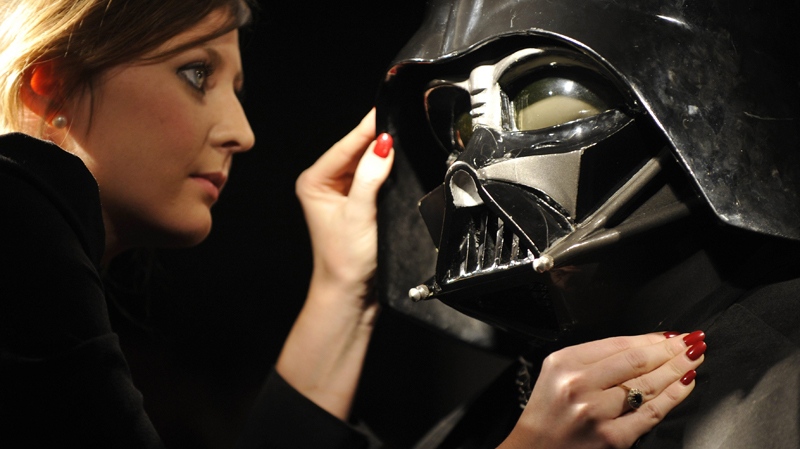 Christie's employee Caitlin Graham poses with a Darth Vader costume in London, Wednesday, Oct. 27, 2010. (AP / Lennart Preiss)