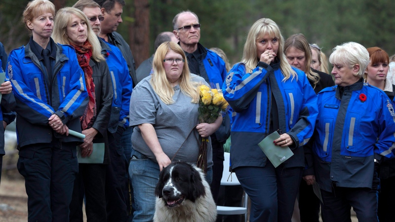 People attend the British Columbia Society for the Prevention of Cruelty to Animals burial service of remembrance for 56 sled dogs south of Penticton, B.C. on Friday November 2, 2012. (Jeff Bassett / THE CANADIAN PRESS) 