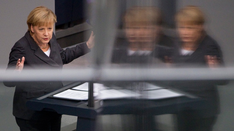 German Chancellor Angela Merkel is reflected in a glass panel as she delivers a speech at the German Federal Parliament Bundestag in Berlin, Germany, Wednesday, Oct. 27, 2010. (AP / Gero Breloer)