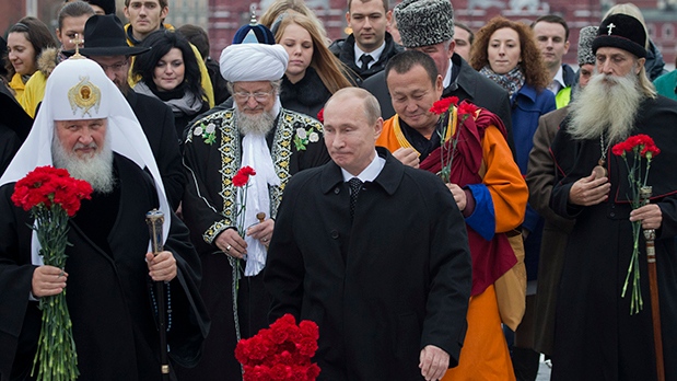Vladimir Putin walks in Russia's Red Square