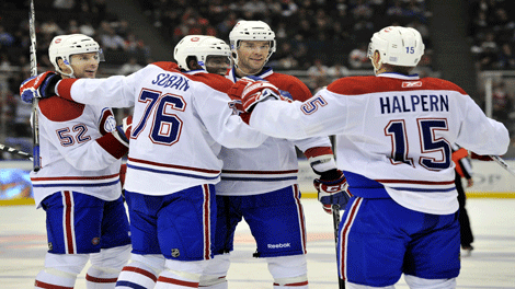 Montreal Canadiens' Benoit Pouliot, second from right, celebrates his goal with teammates Mathieu Darche (52), P.K. Subban (76) and Jeff Halpern (15) against the New York Islanders during the third period of an NHL hockey game, Friday, Oct. 29, 2010, in Uniondale, N.Y. Montreal won 3-1. (AP Photo/Kathy Kmonicek)