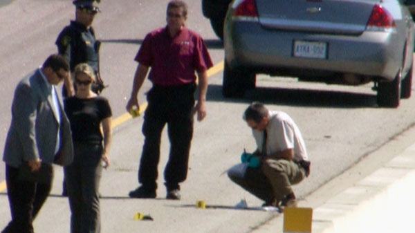 SIU investigators gather evidence at the scene on Highway 401 on Saturday, Aug. 28, 2010.