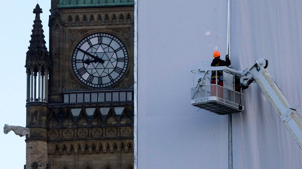 Workers install a protective barrier on the north end of West Block during continuing renovations on Parliament Hill in Ottawa, Thursday Oct. 15, 2009. (Adrian Wyld / THE CANADIAN PRESS)