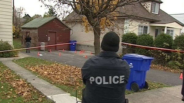 Gatineau police probe the scene of a fatal stabbing in Hull, Saturday, Oct. 30, 2010.