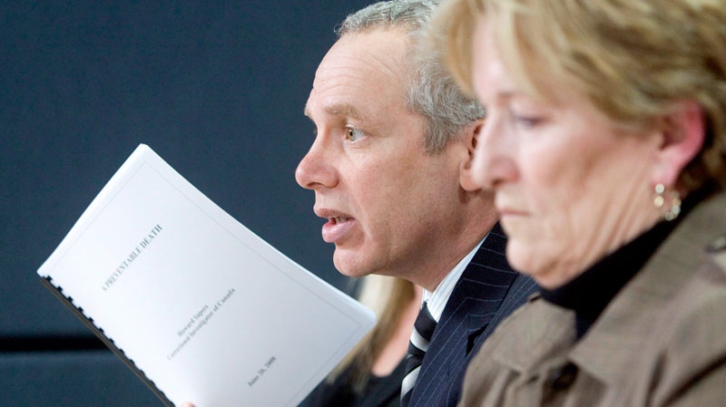 Julian Falconer(left), lawyer for the Smith family, holds up a copy of the Correctional Investigators report as Coralee Smith, the mother of Ashley Smith, looks on at a news conference in Ottawa, Wednesday, March 4, 2009. (Tom Hanson / THE CANADIAN PRESS)