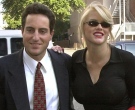Anna Nicole Smith smiles as she walks to the courthouse with Howard Stern, her attorney, in this file photo from Oct. 2, 2000 in Houston. (AP / Brett Cooomer)