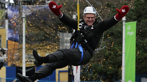 British Columbia Premier Gordon Campbell rides a zipline setup to coincide with festivities during the Vancouver Winter Olympics in Vancouver, B.C., on Friday February 5, 2010. THE CANADIAN PRESS/Darryl Dyck
