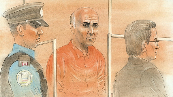 Vakhtang Makhniashvili(centre) wore an orange prisoner's jumpsuit during his appearance in a Toronto court on Friday, Nov. 5, 2010.