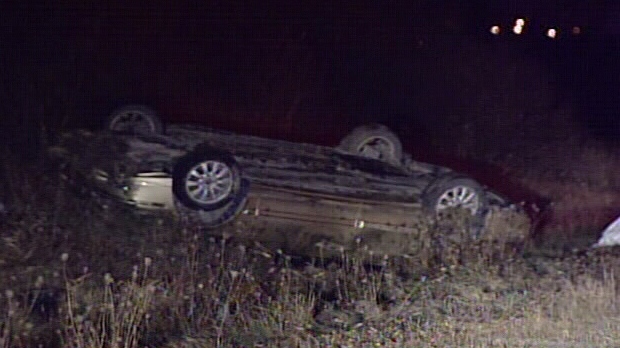 A car lies on its roof after running into a moose on Highway 417 in Ottawa Wednesday, Nov. 14, 2012.