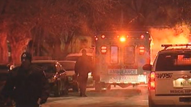 Police and emergency crews respond to the shooting  in the 400 block of Martin Avenue West in Elmwood in December 2009. Two men were killed and a third wounded.

