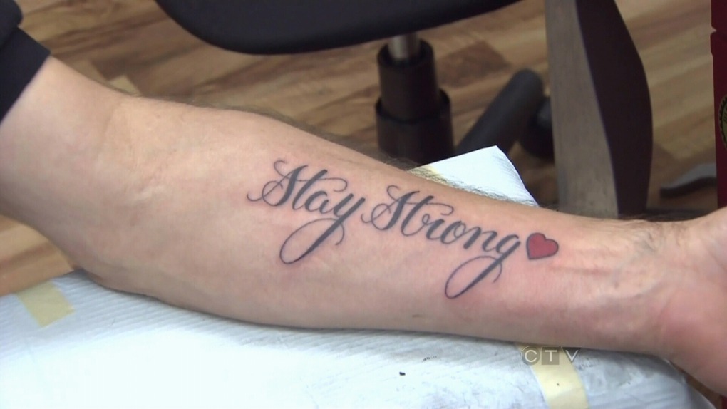 Little upper back tattoo that says Stay Strong on