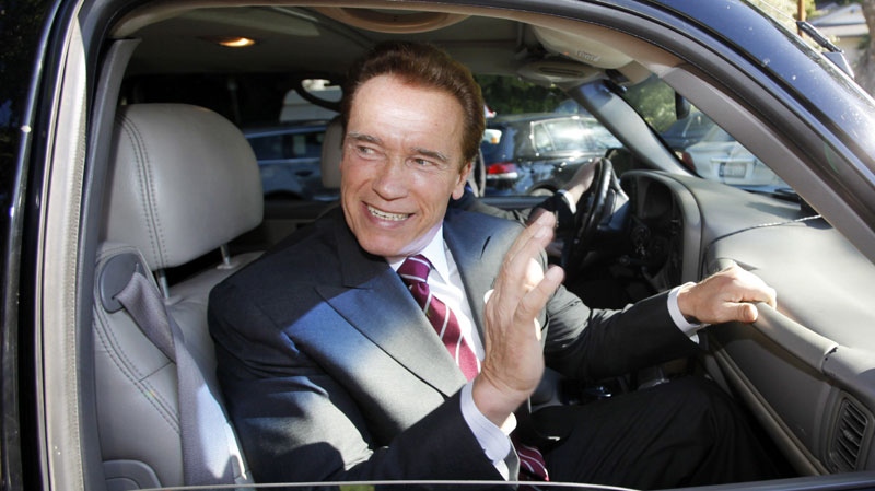 California Gov. Arnold Schwarzenegger waves as he leaves after voting at an elementary school near his home in the Brentwood district of Los Angeles Tuesday, Nov. 2, 2010. (AP Photo/Reed Saxon) 