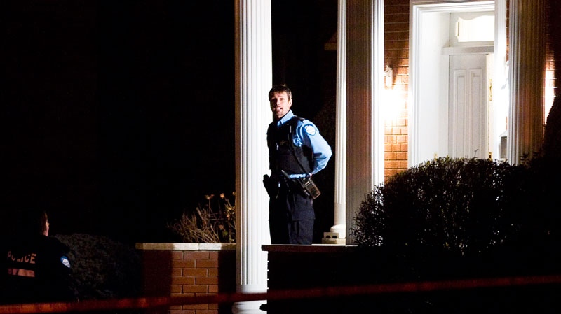 A police officer guards the entrance of the house of reputed mafia boss Nicolo Rizzuto Sr., who was reportedly gunned down in his home in Montreal, Wednesday, Nov. 10, 2010.(Graham Hughes / THE CANADIAN PRESS)
