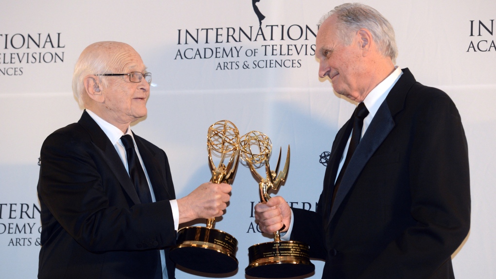 Alan Alda touches statues with Norman Lear