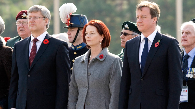 Prime Minister Stephen Harper takes part in a Remembrance Day ceremony with Australian Prime Minister Julia Gillard and Prime Minister of the United Kingdom David Cameron at the Korean War Memorial in Seoul, Korea, Thursday, Nov. 11, 2010. (Adrian Wyld / THE CANADIAN PRESS)
