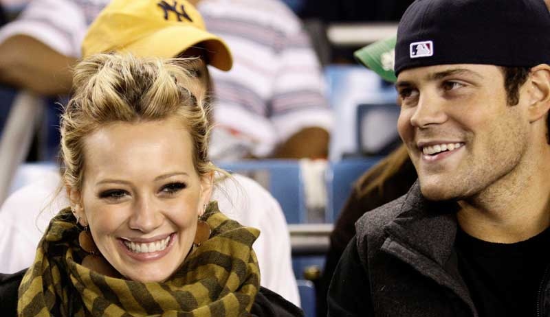 Actress and singer Hilary Duff, left, attends the New York Yankees' baseball game against the Chicago White Sox with New York Islanders center Mike Comrie at Yankee Stadium in New York, Tuesday, Sept. 16, 2008.