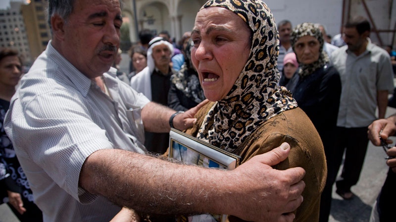 Samira Rahmoon, right, the wife of Lebanese TV psychic Ali Sibat who was arrested by the Saudi religious police in May 2008 and sentenced to death last November on charges of practicing witchcraft, reacts as a relative tries to comfort her during a sit-in in front of the Government House in Beirut, Lebanon, Friday, June 11, 2010. (AP / Grace Kassab)