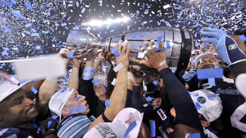 Toronto Argonauts players hold the Grey Cup after defeating the Calgary Stampeders in CFL action in Toronto, Sunday, Nov. 25, 2012. (Nathan Denette / THE CANADIAN PRESS)