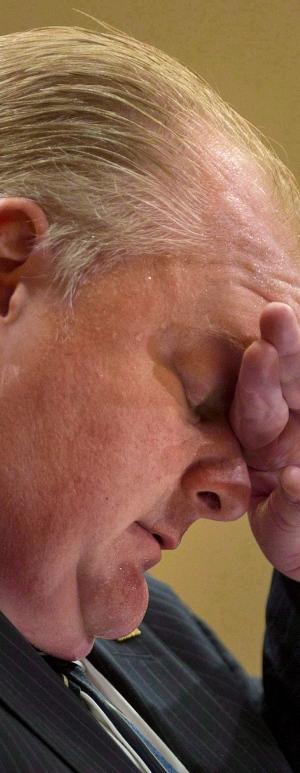 Toronto Mayor Rob Ford wipes his forehead 