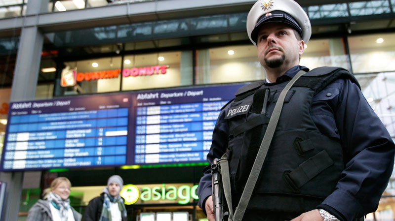 A police officer wearing a bulletproof vest stands guard at the main train station in Berlin, Germany, Wednesday, Nov. 17, 2010. (AP / Michael Sohn)