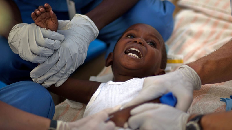 A child with cholera symptoms is treated by volunteer American doctors at a hospital in Archaie, Haiti, Monday, Nov. 15, 2010. (AP / Ramon Espinosa)