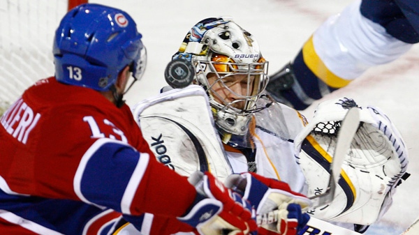 Nashville Predators goaltender Pekka Rinne, from Finland, stops a puck deflected by Montreal Canadiens' Michael Cammalleri during third period NHL hockey action Thursday, November 18, 2010 in Montreal. The Predators shutout the Canadiens 3-0. THE CANADIAN PRESS/Paul Chiasson