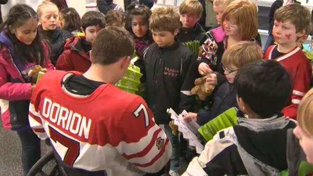 The players sign autographs for the kids.