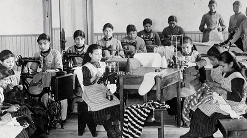 Students learn how to sew at Fort Resolution Indian Residential School (St. Joseph's Convent), in Resolution, N.W.T., in this undated image. (Library and Archives Canada)