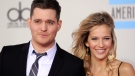 Michael Buble and Luisana Lopilato arrive at the 38th Annual American Music Awards on Sunday, Nov. 21, 2010 in Los Angeles. (AP / Chris Pizzello)