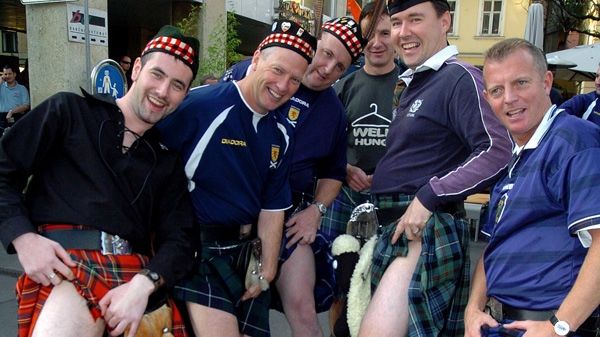 In this Tuesday, Oct. 11, 2005 file photo Scottish soccer fans pose with their kilts in Ljubljana, Slovenia. (AP Photo/Denis Sarkic, File)