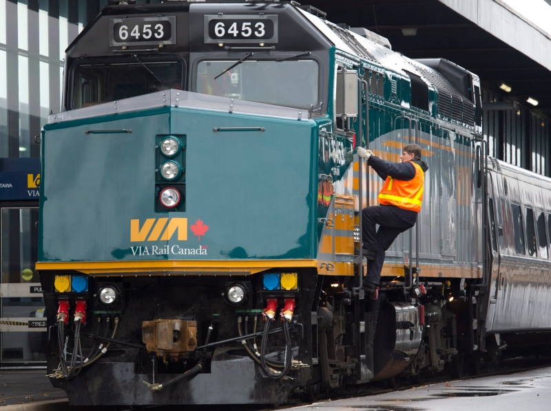 A Via Rail employee climbs aboard an F40 locomotive at the train station in Ottawa on Monday, December 3, 2012. (Adrian Wyld / THE CANADIAN PRESS)
